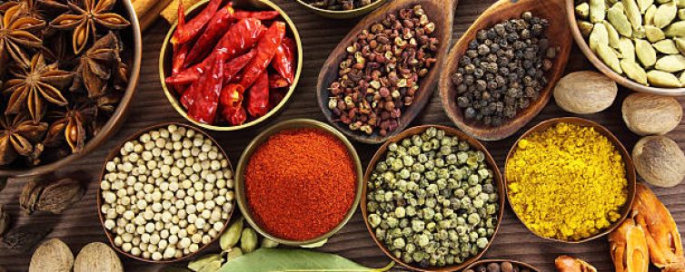 Spices and herbs in metal  bowls and wooden spoons. Food and cuisine ingredients.